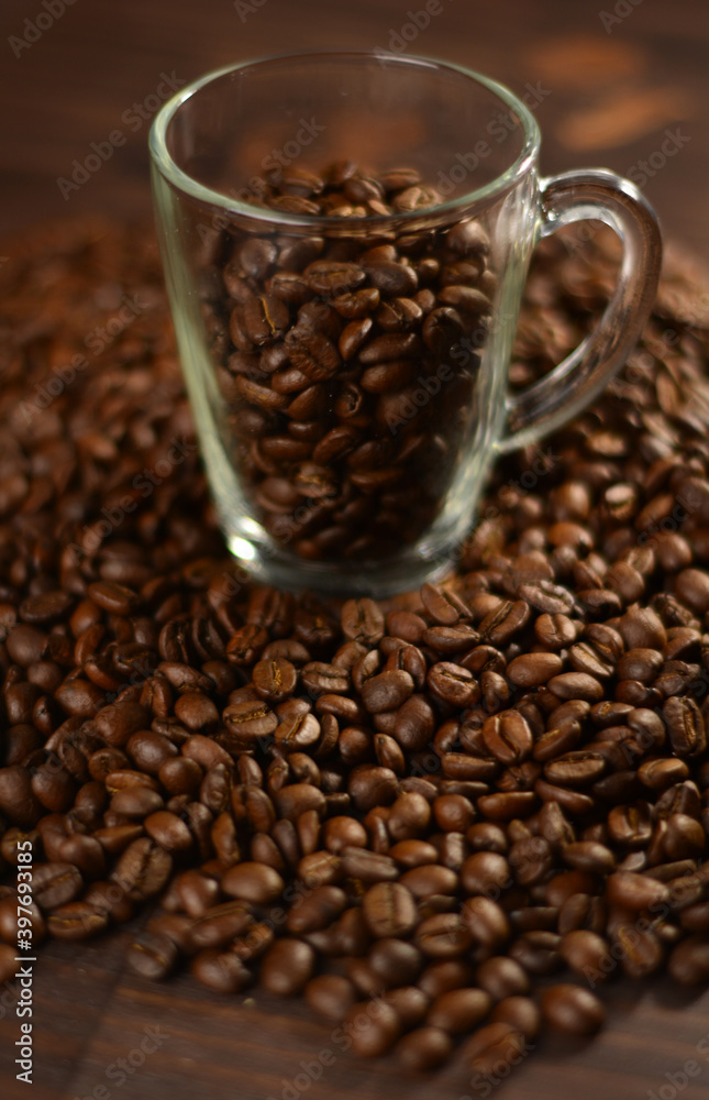 Fototapeta premium Roasted coffee beans on a wooden table