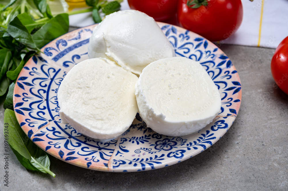 Fresh handmade soft Italian cheese from Campania, white balls of buffalo mozzarella cheese made from cow milk ready to eat Fresh handmade soft Italian cheese from Campania, white balls of buffalo mozzarella cheese made from cow milk ready to eat