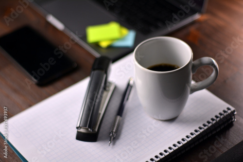 Coffee and office supplies on a wooden table