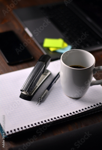 Coffee and office supplies on a wooden table