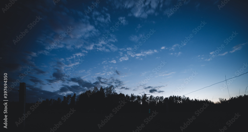 Naklejka premium Lots of stars showing in the night sky over a forested area in the Czech Republic.