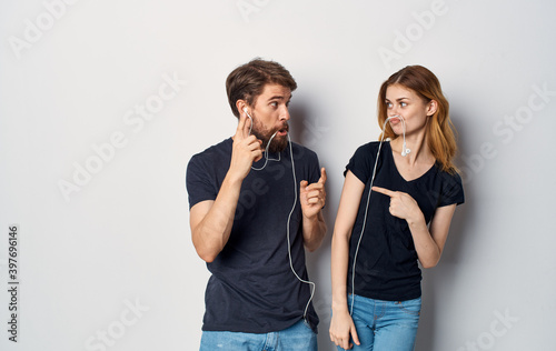 young couple in headphones listening to music fun friendship emotions