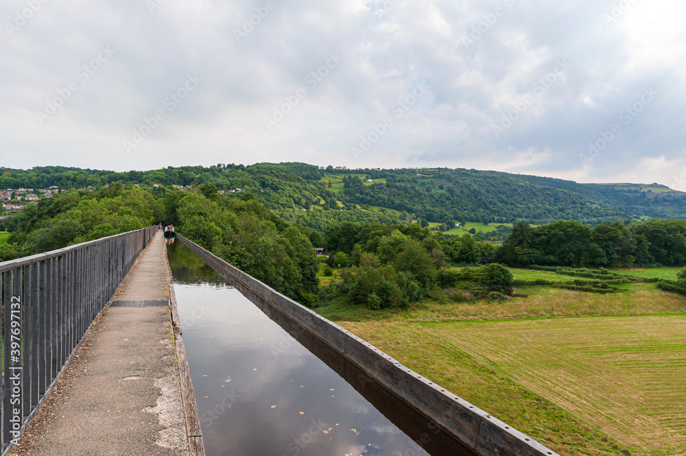 Pontcysyllte Aqueduct, carries the Llangollen Canal waters across the River Dee in the Vale of Llangollen in Wales. 18-arched stone and cast iron structure is for use by narrow, canal-boats. UK