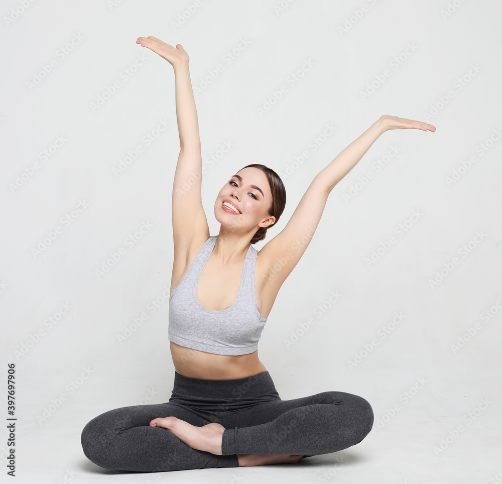 Healthy female isolated on white practicing yoga. A beginner yoga woman is in basic yoga pose. The position required good stretching and balance.