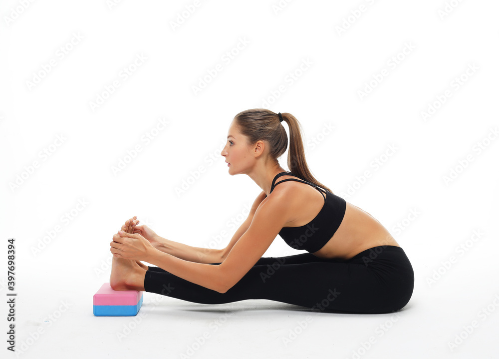 Yoga and fitness concept:Woman practicing yoga with yoga block over white background Yoga and fitness concept:Woman practicing yoga with yoga block over white background