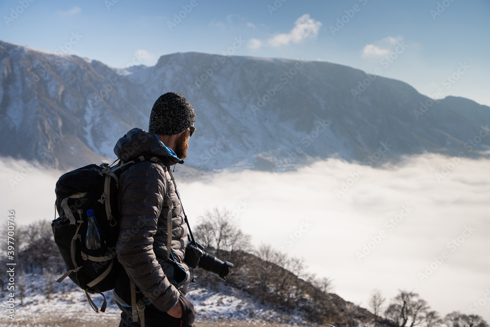 portrait of handsome man trekking in mountains in winter  outdoor adventure active lifestyle and social distancing space for your text
