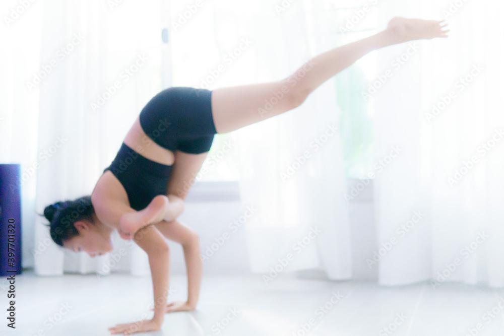 Young Asian woman practice yoga in bedroom in the morning Young Asian woman practice yoga in bedroom in the morning