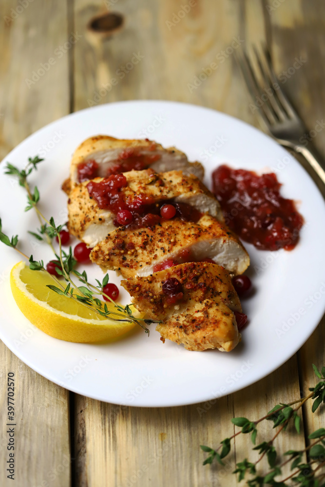 Turkey fillet with cranberry sauce presented on a plate. Christmas dinner. Healthly food.