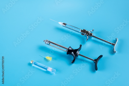 Dentistry medical tools syring on blue background.