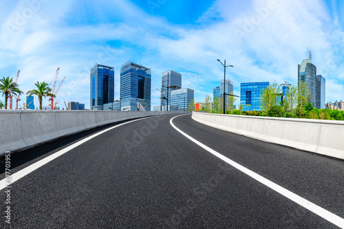 Empty asphalt road and Shanghai skyline with buildings scenery.