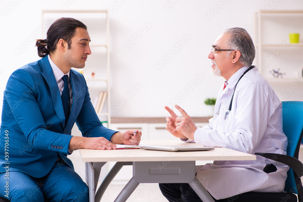 Young businessman meeting with old doctor Young businessman meeting with old doctor