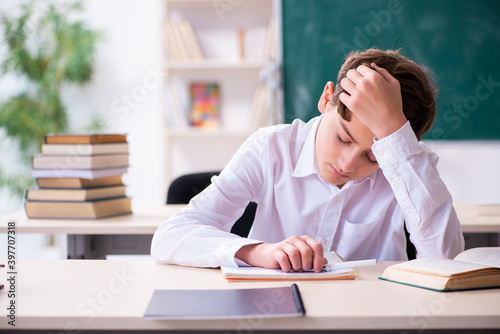 Schoolboy preparing for exams in the classroom