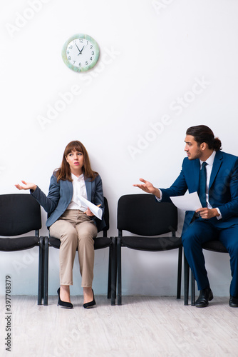 Young businessman and businesswoman waiting for an interview at