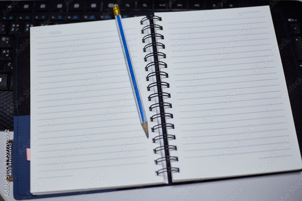 Book with pencil on working table Book with pencil on working table