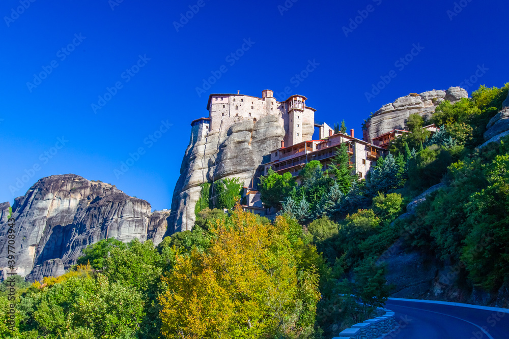 Greece. Thessaly. Kalambaka. The Rusanu Monastery. The monastery complex is located on the rocks. A stone temple on top of a cliff. Meteora Monasteries in Greece. Thessaly in sunny weather
