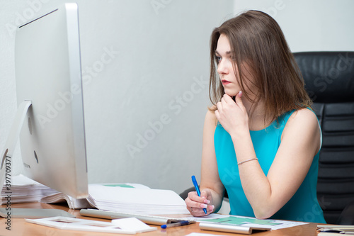 Girl works in an office wit...