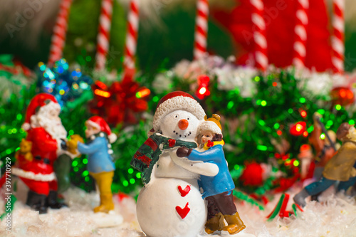 Christmas holiday decorations scene child hugging a snow man