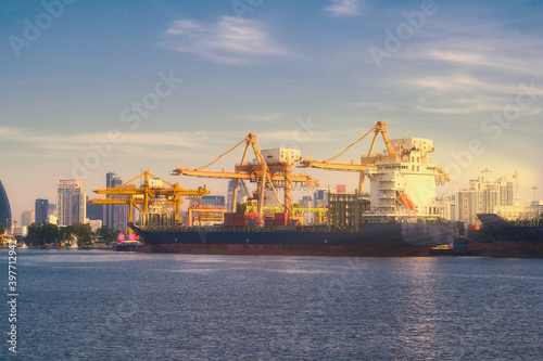International Container Cargo ship with working crane bridge in shipyard background, logistic import export background and transport industry.