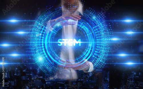Business  Technology  Internet and network concept. Young businessman working on a virtual screen of the future and sees the inscription  STEM