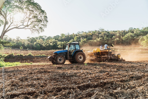 Farmer drives a tractor on a sunny summer day