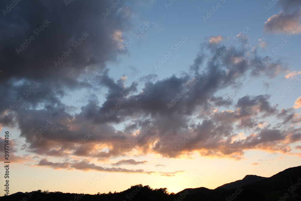 cloud and vanilla sky background with dark mountain silhouette