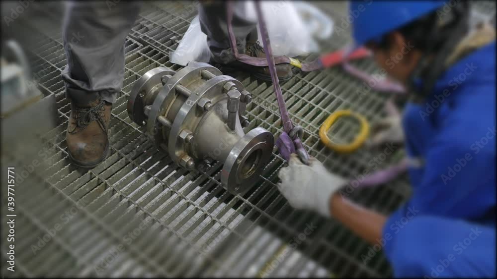 Mechanics are servicing the machines in the factory to prepare for the next production run.