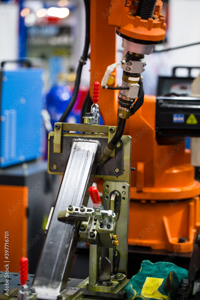 Industrial robot arm welding structural beam in construction heavy industry. Industrial robot arm welding structural beam in construction heavy industry.