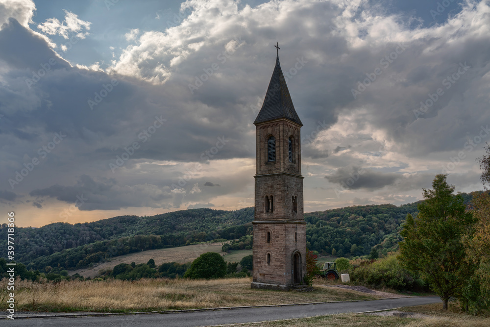 The lonely steeple of falkenstein at the donnersberg in rhineland-palatinate, Germany. The legend tells that there was no money to build the church to the tower