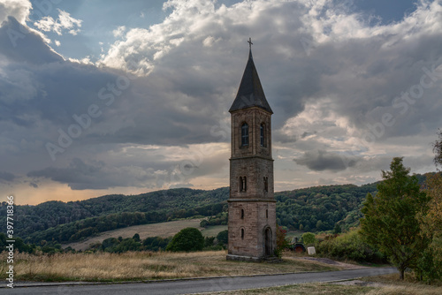 The lonely steeple of falkenstein at the donnersberg in rhineland-palatinate, Germany. The legend tells that there was no money to build the church to the tower