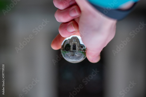 A Church Door With Christmas Wreaths on It in a Glass Photography Ball