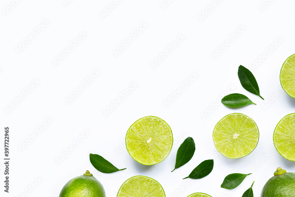 Limes with leaves isolated on white.