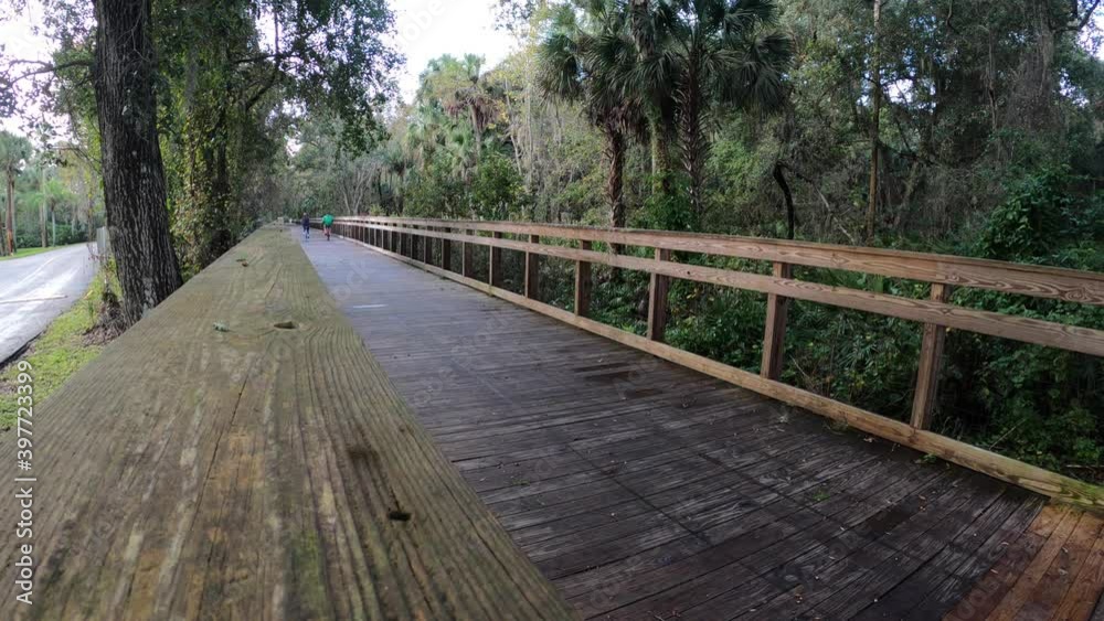 Bikers on boardwalk trail Bikers on boardwalk trail