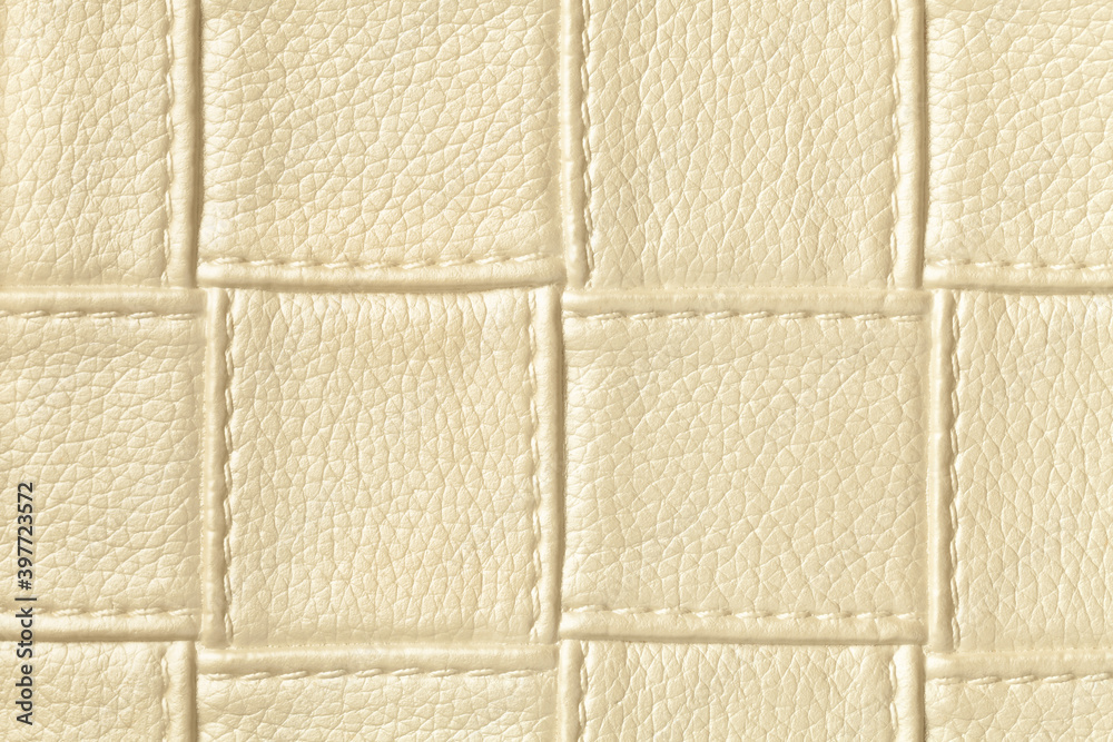 Fototapeta premium Texture of golden and cream leather background with square pattern and stitch.