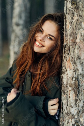 Smiling woman in warm jacket in the forest vacation lifestyle