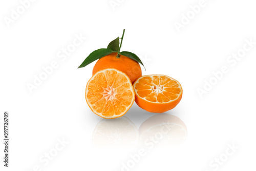 Three Tangerine or clementine with green leaf isolated with reflection on white background