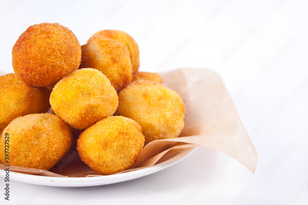Potato croquettes balls on the plate on the white background. Potato croquettes balls on the plate on the white background.