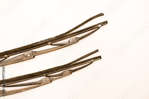 Damaged old grimy wiper blades isolated against a white background. 