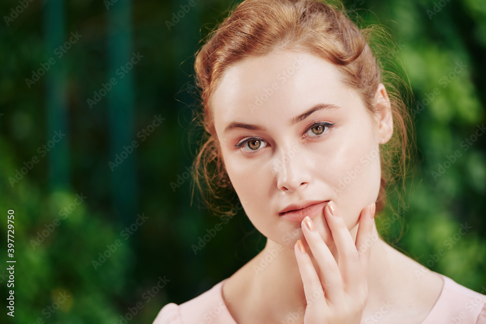 Portrait of young beautiful pensive woman with natural make-up looking at camera Portrait of young beautiful pensive woman with natural make-up looking at camera