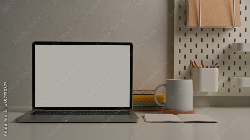 Workspace with laptop, stationery and supplies in home office room Workspace with laptop, stationery and supplies in home office room