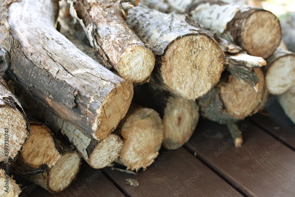 pile of firewood. stacked wood logs on wooden background pile of firewood. stacked wood logs on wooden background