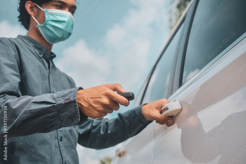Businessman wear face mask holding key opening car door Businessman wear face mask holding key opening car door