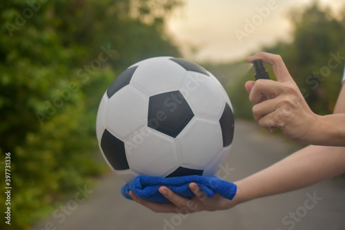 Hand cleaning football by alcohol protect coronavirus covid19