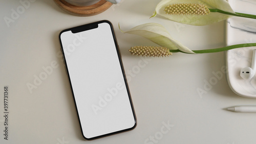 Smartphone include clipping path on white table with accessory and flower