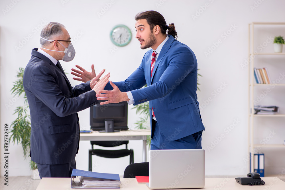 Two employees at workplace during pandemic Two employees at workplace during pandemic