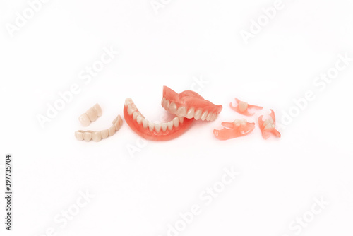 Dentures on a white background. Close-up of dentures. Full removable plastic denture of the jaws. Prosthetic dentistry. False teeth. Close-up of plastic dentures. Teeth on a white background