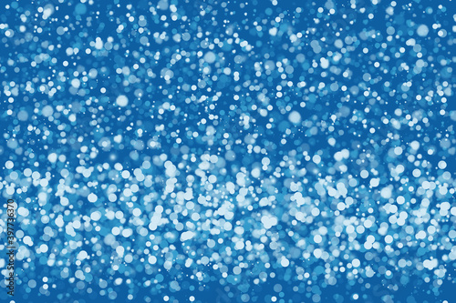 Blue snowy background for design. Shimmering snow flakes  defocus bokeh effect. Background decoration illustration