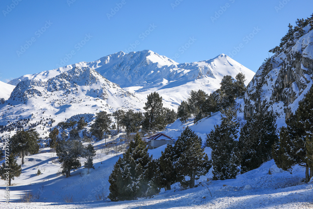 Winter Mountains landscape with snow covered peaks Against blue Sky in Saklikent Antalya Turkey Winter Mountains landscape with snow covered peaks Against blue Sky in Saklikent Antalya Turkey