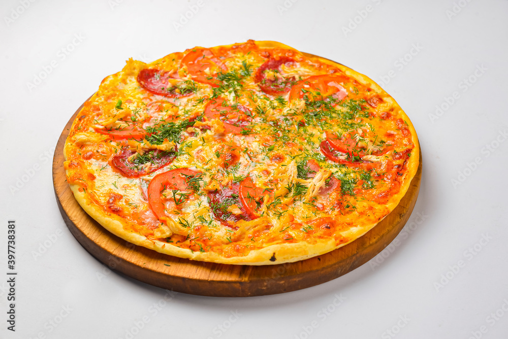 Pepperoni pizza on a white background. Traditional Italian pizza with tomatoes and meat isolated on white.