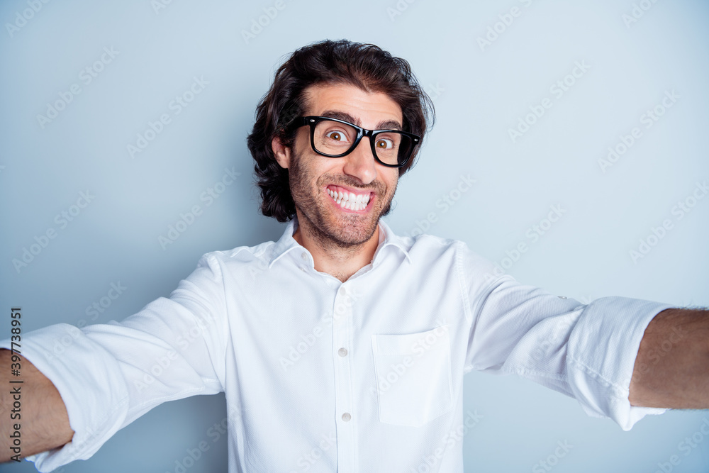 Photo of young excited arabian man happy toothy smile make take selfie isolated over grey color background Photo of young excited arabian man happy toothy smile make take selfie isolated over grey color background