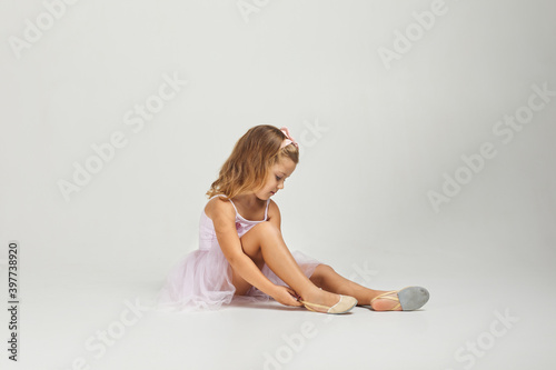 little child girl dreams of becoming a ballerina. ballet dancer in pink tutu